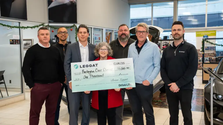 People holding a large cheque celebrating that Leggat is donating $1,000 to the Burlington Civic Chorale.
